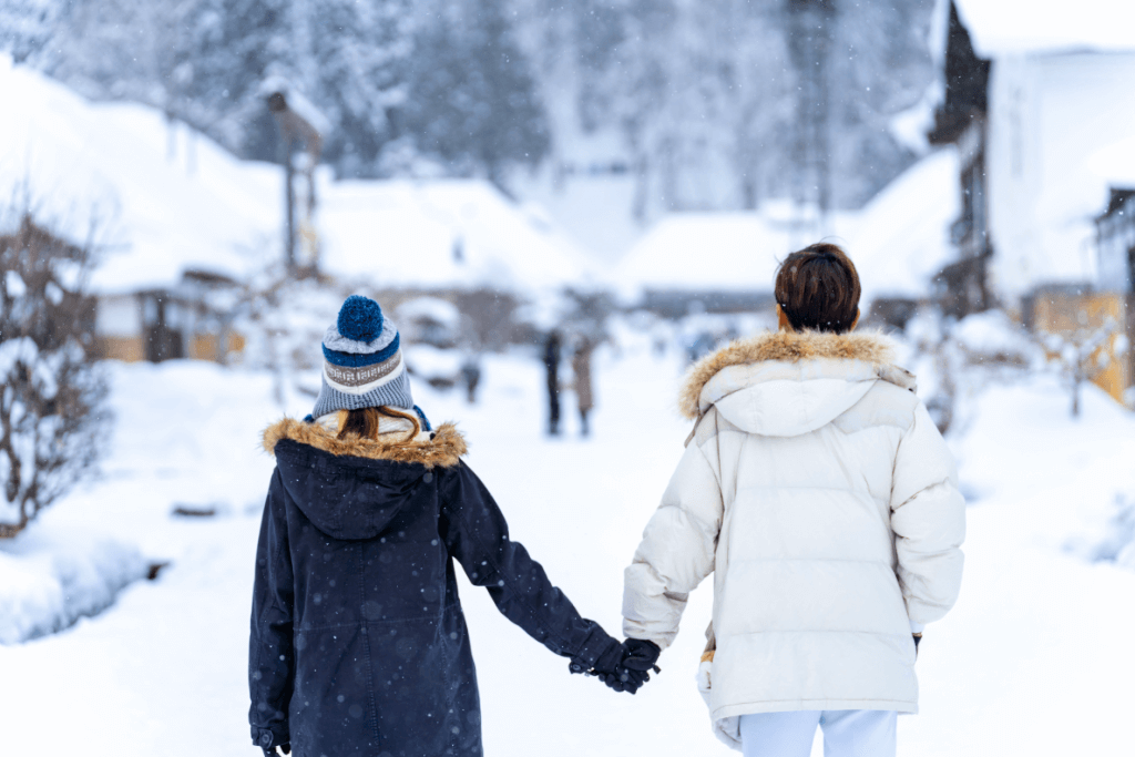A couple holding hands in the winter. 