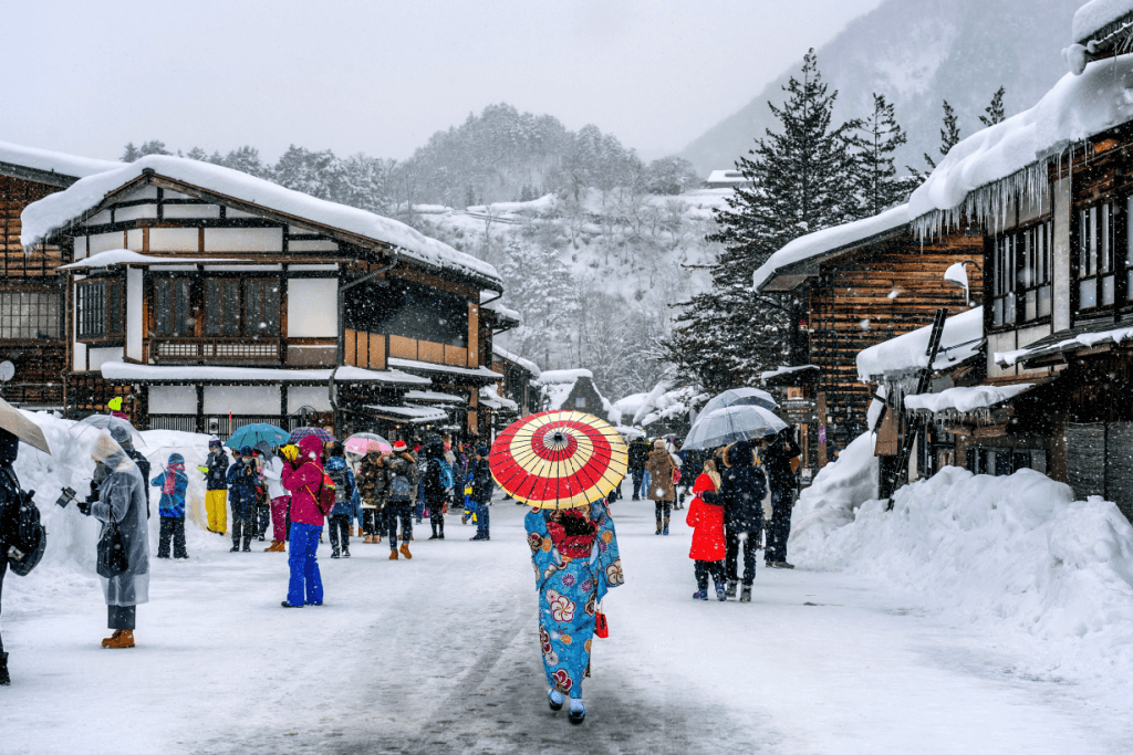 A woman wearing a kimono at Shirakawa-go village during the snowy happy holidays.