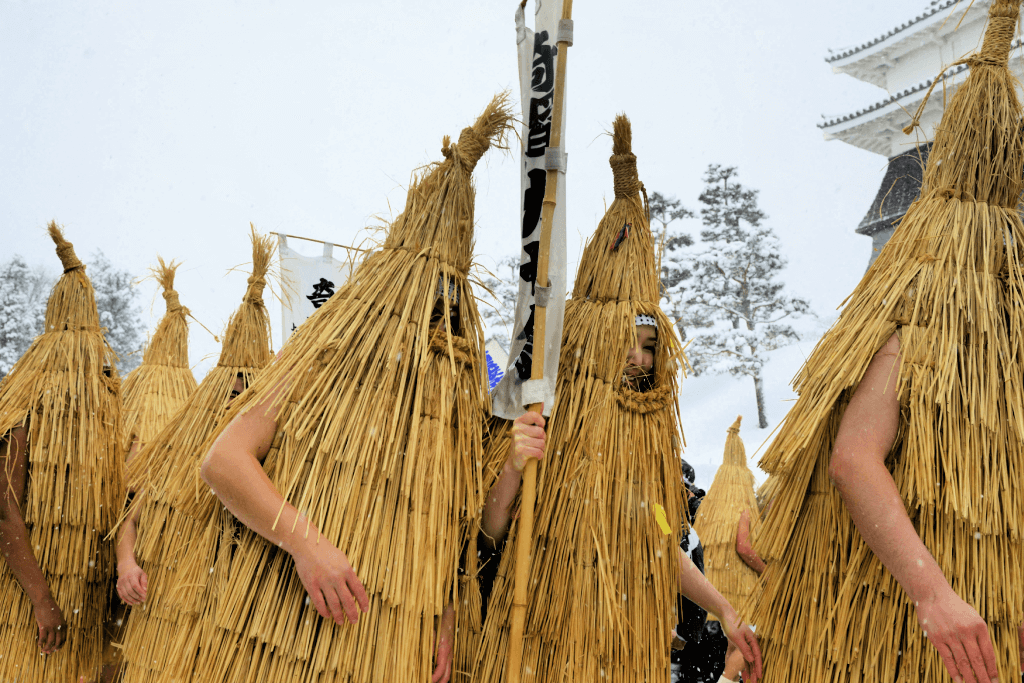 People dressed in straw costumes at the Kasedori Festival.