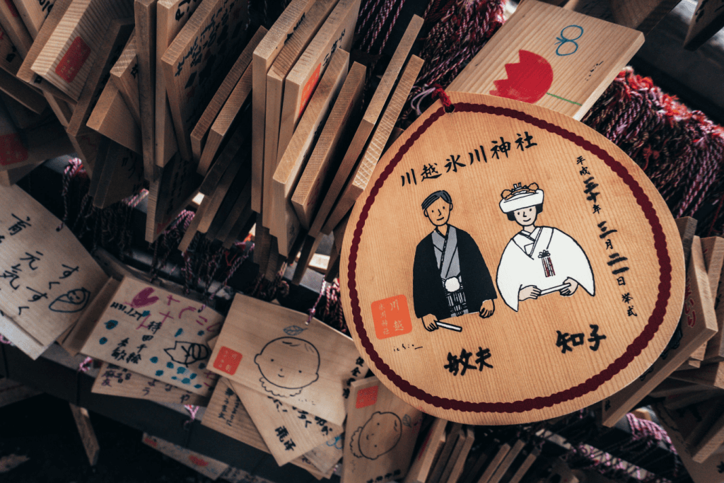 An wooden ema board depicted a Japanese married couple.