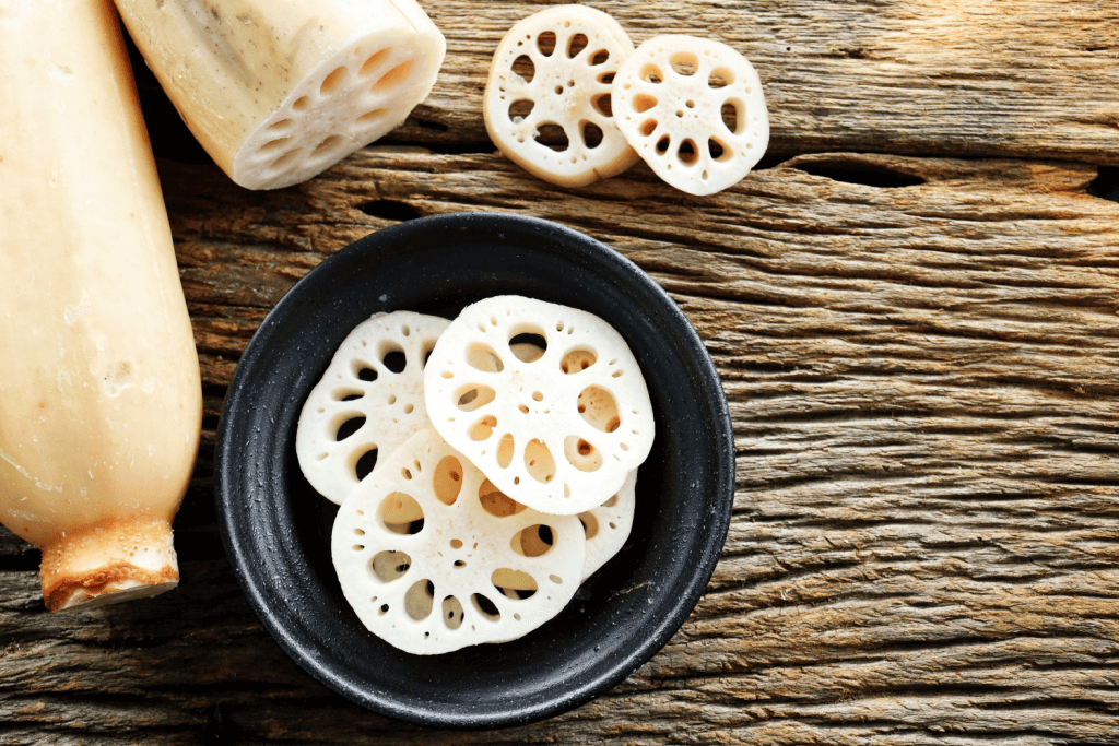 Slices of lotus root, with a whole root on the side.