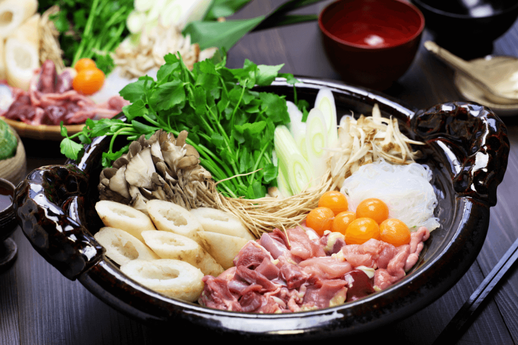 A nabe pot full of vegetables, meat and eggs.