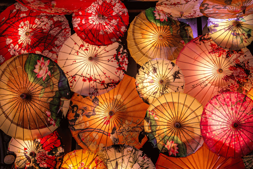 A bunch of backlit Japanese parasols.