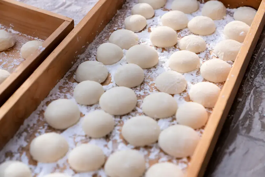 A bunch of plain mochi on a counter.