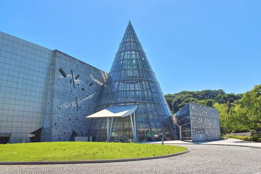The outside of Ehime Prefectural Science Museum. It has a large metal cone at the front.