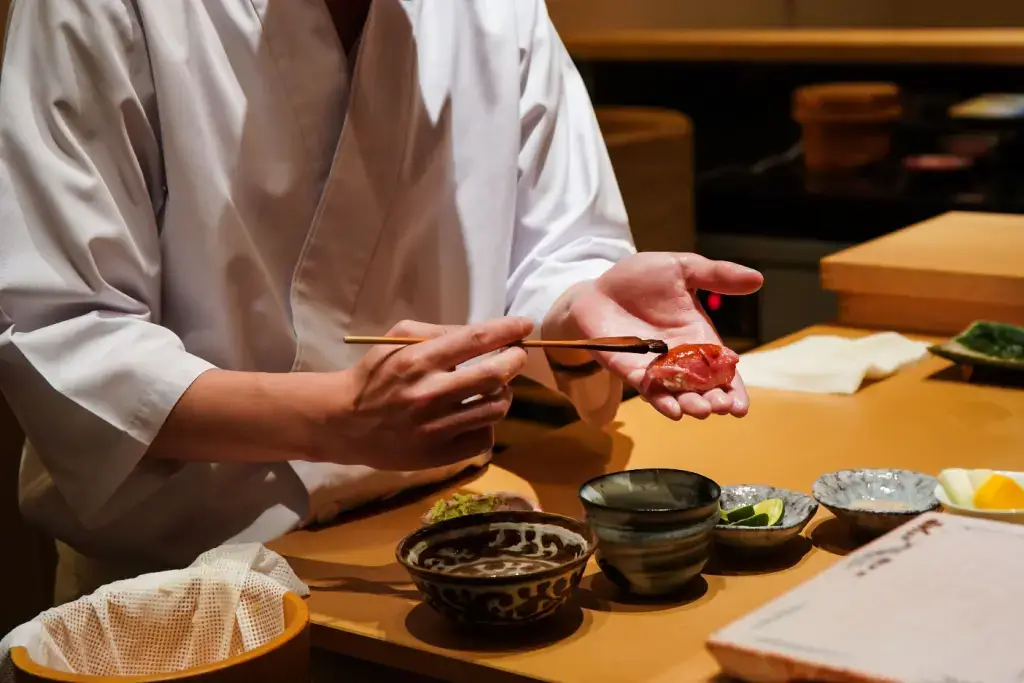A chef preparing sushi for omakase dining.