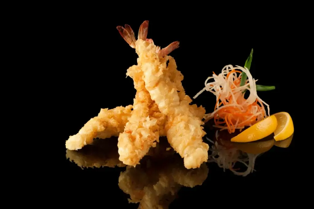 Tempura shrimp against a dark background.