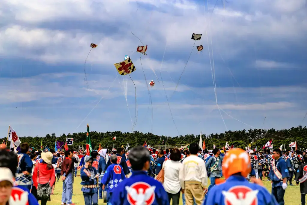 People flying kites at the Hamamatsu Festival.