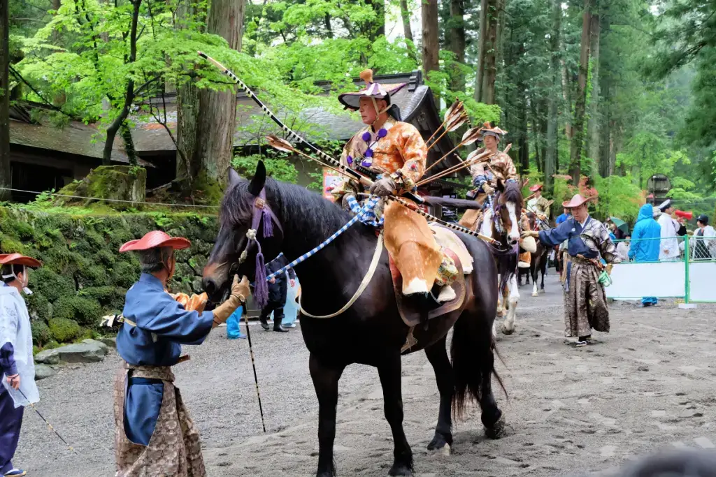 A person riding on horseback at the Yabusame Shinji Festival.