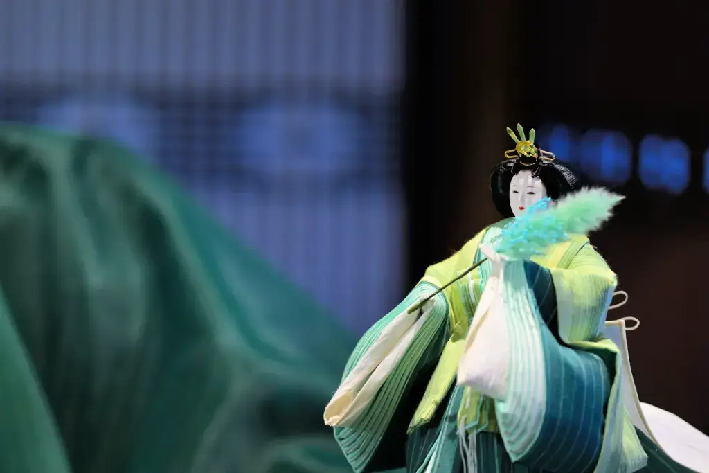A dark green Hina Doll representing the empress regnant.