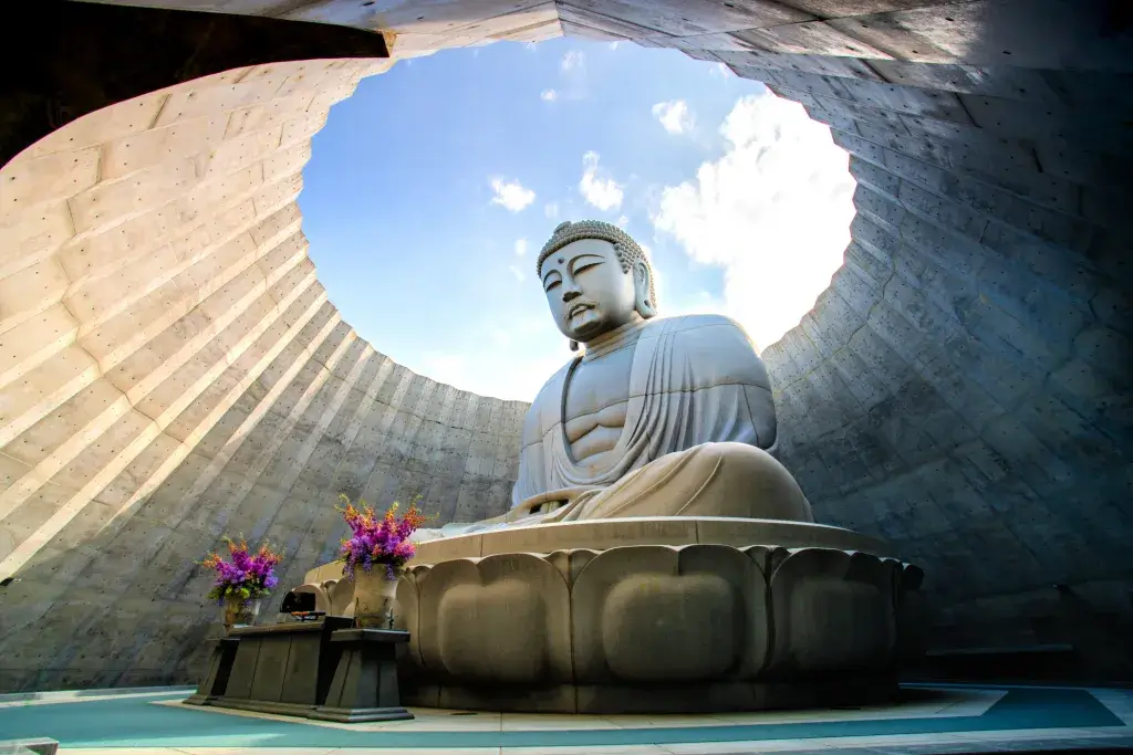 A large Buddha statue in a roofless dome in Hokkaido.