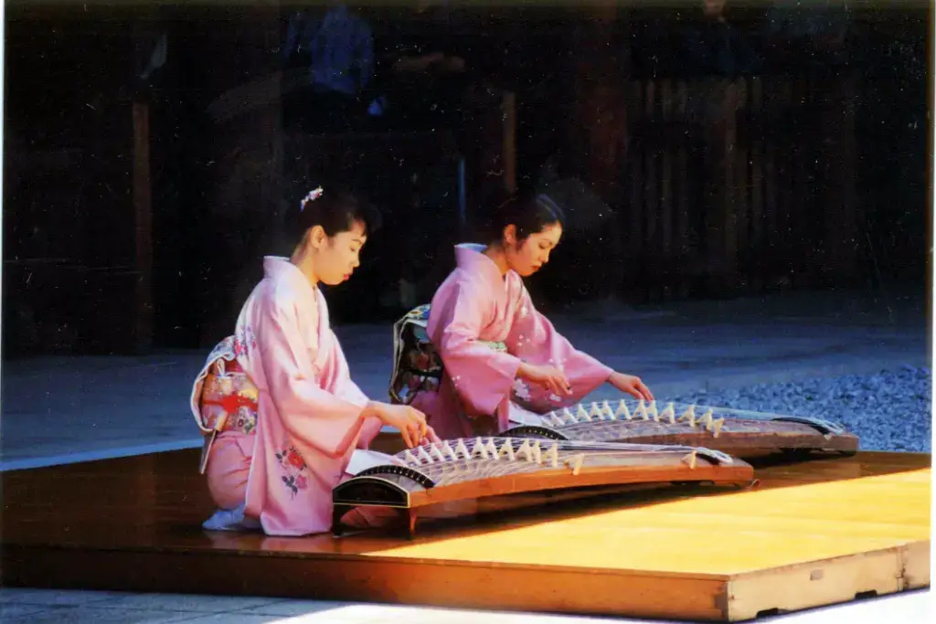 Two women playing the koto.