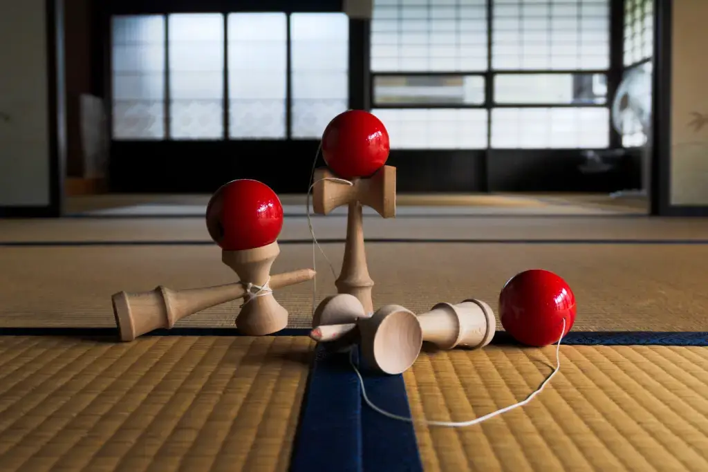 Three kendamas on a tatami mat, one of many traditional Japanese games.