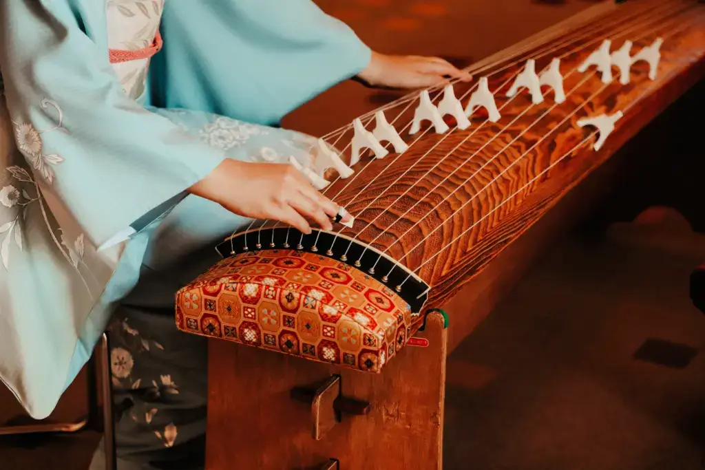 Someone playing a koto, one of many traditional Japanese instruments.