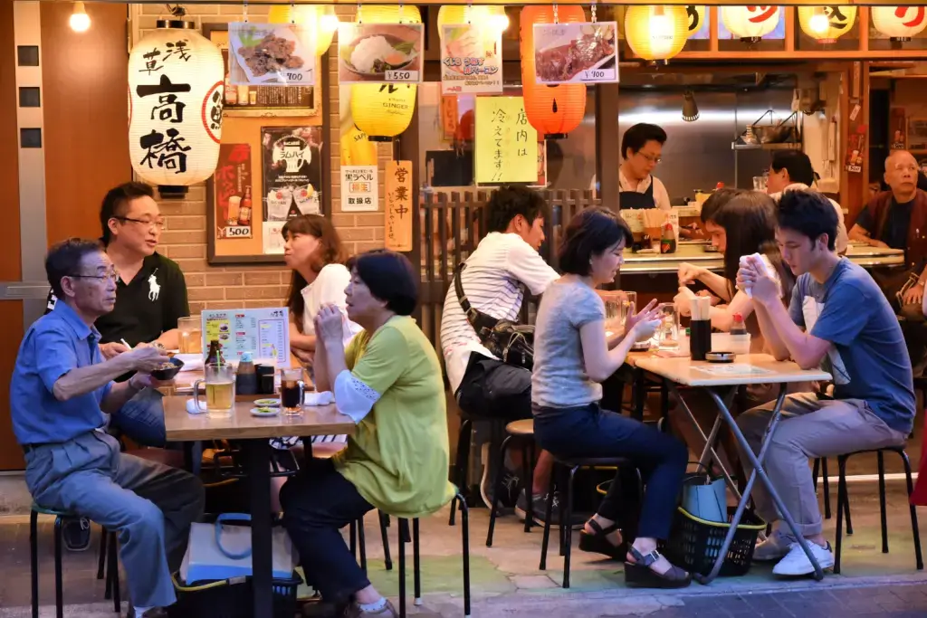 People relaxing at an outdoor izakaya.