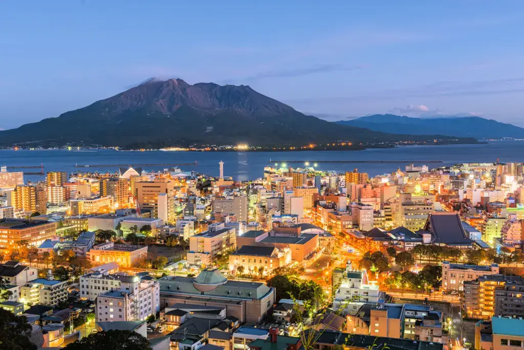 Mount Sakurajima, a volcano at night, near the city.