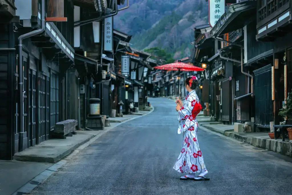 A woman in a kimono in a mountainside town in Nagano.