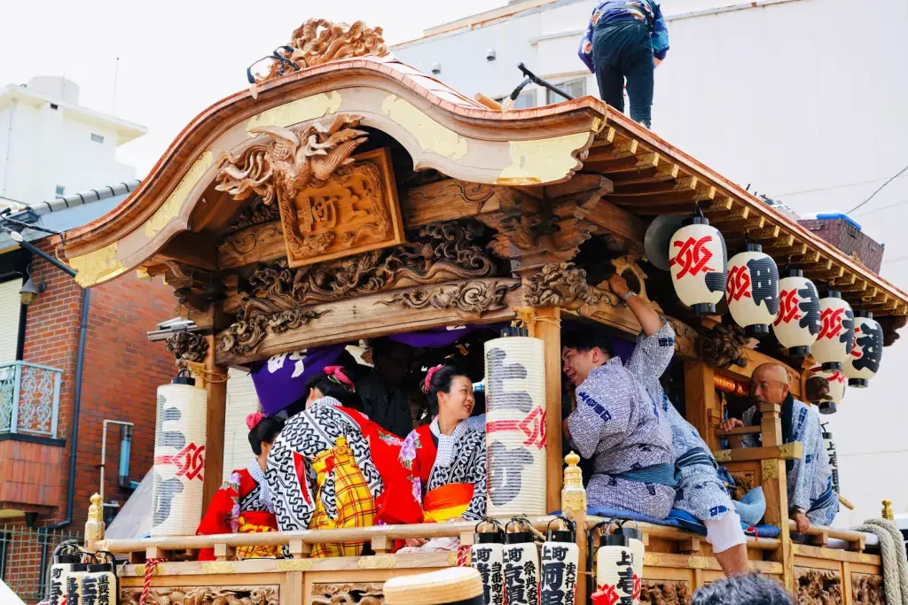 Women riding in an elaborate, mikoshi-like float at the Narita Gion Festival. It has mikoshi, like the Tenjin festival.
