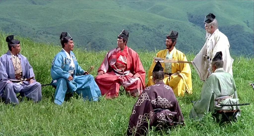 A scene from Ran (1985). Five high ranking officials are in colorful clothes in a field. It's a jidaigeki film.