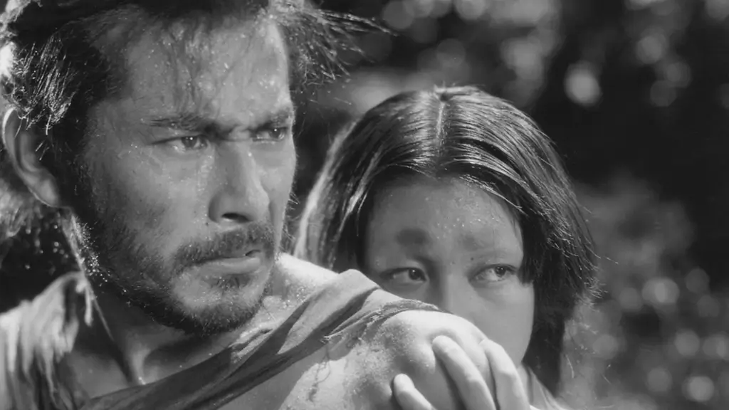 A scene from Rashomon (1950), a woman is hiding behind a man.