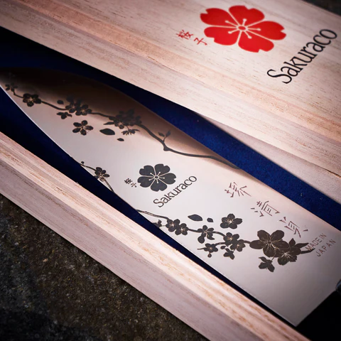 A custom decorative kitchen knife by Sakuraco. It features a cherry blossom motif.