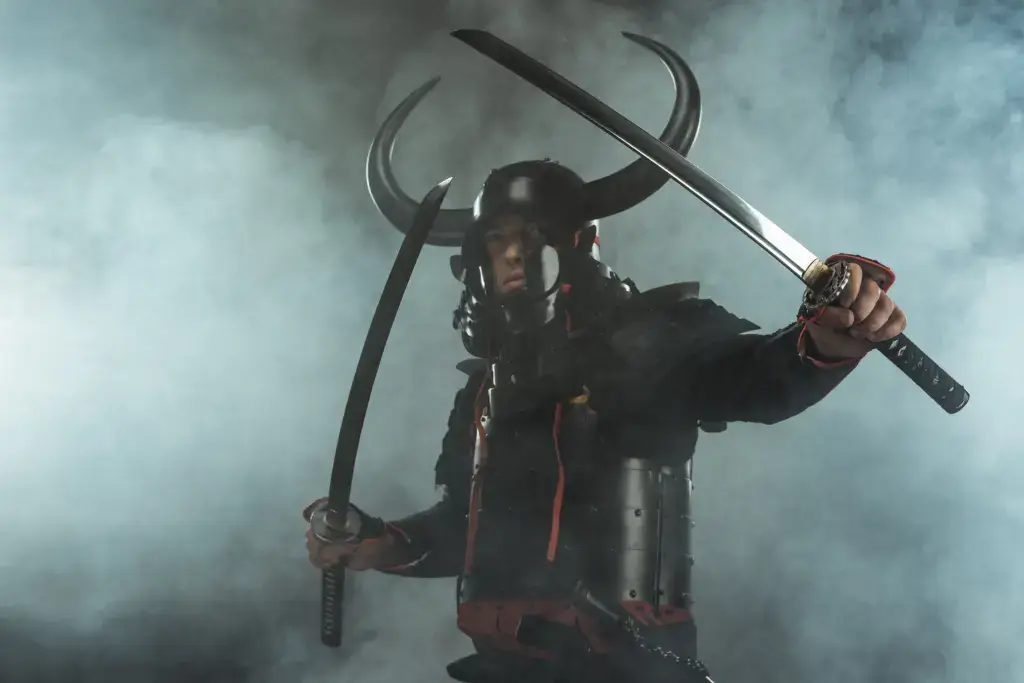 A samurai wielding two swords in battle armor, amongst the fog.