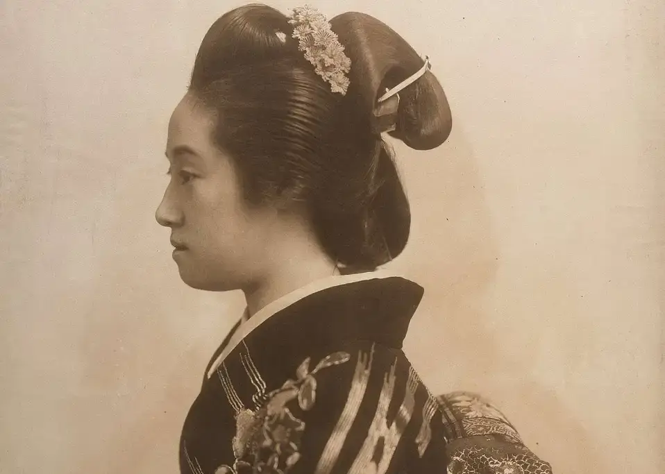 A photo of a woman wearing a shimada mage, one of many Japanese hairstyles.