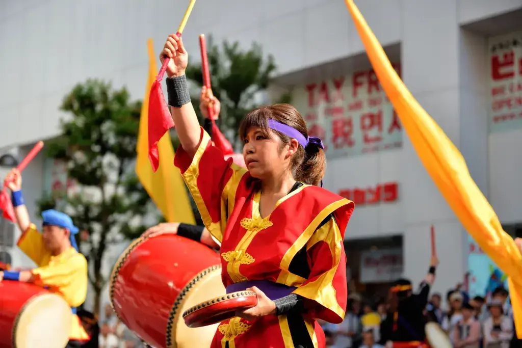 A female drummer dressed in red at the Shinjuku Eisa Festival.
