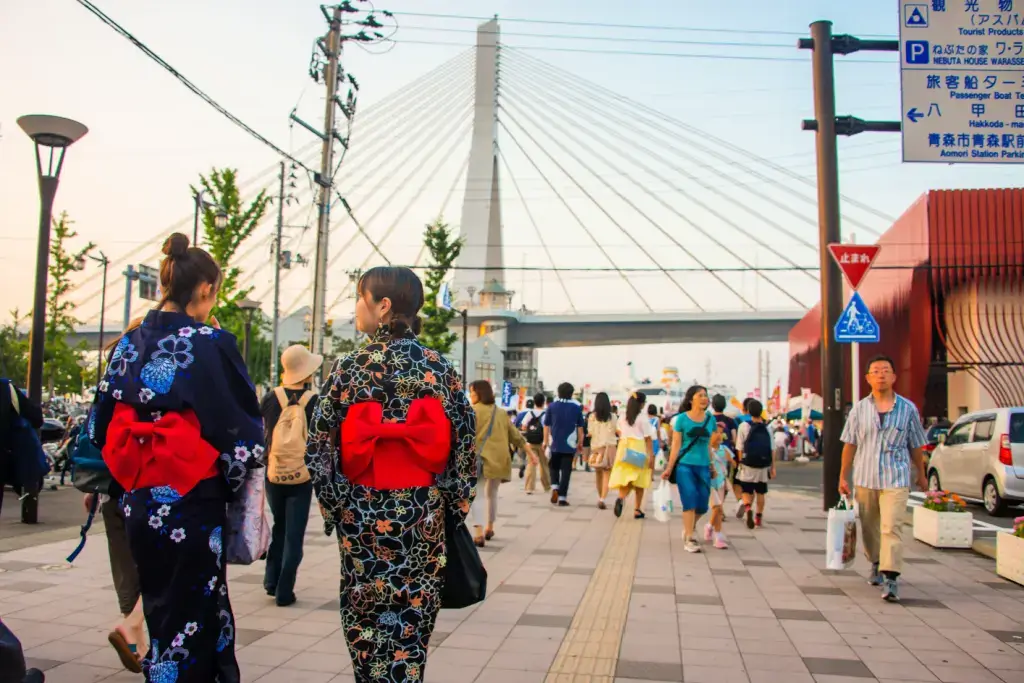 Two women in yukata attending a festival in Aomori.