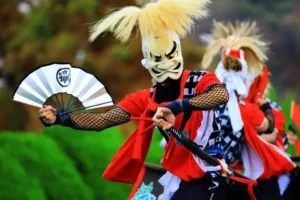 A person wearing a white tengu mask at the Kitakami Michinoku Geino Festival in Tohoku Japan.