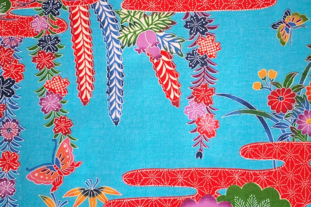 A sheet of blue bingata fabric with red florals.