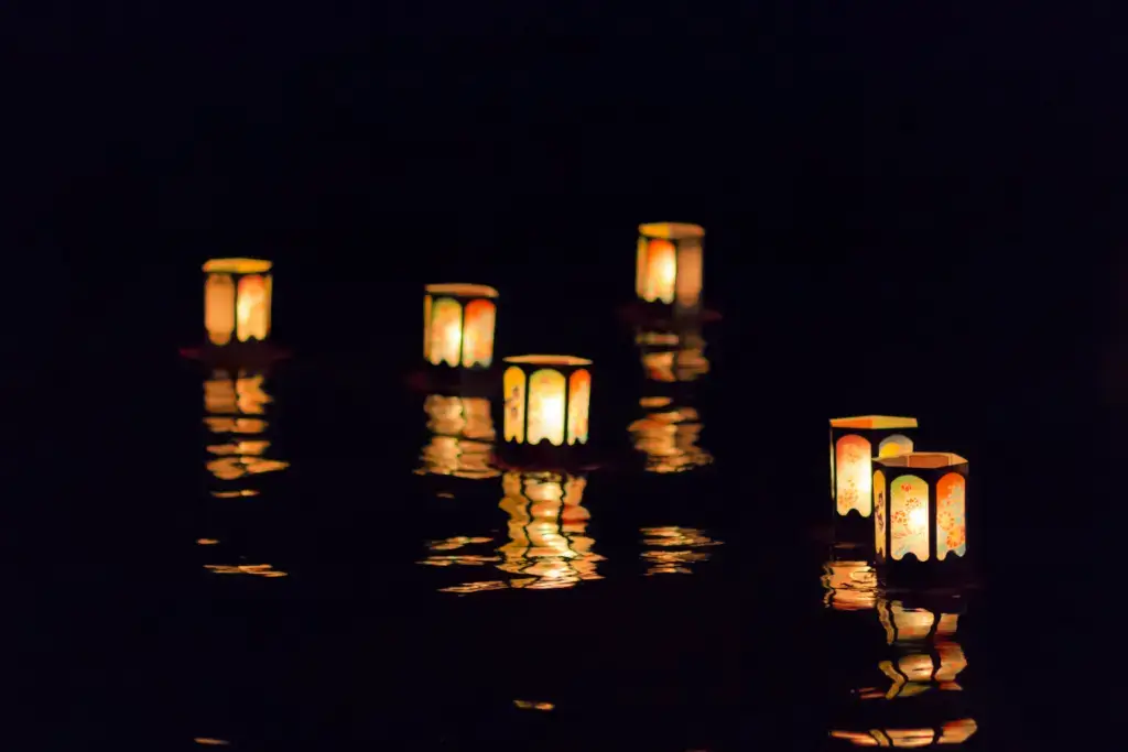 Flowing lanterns down a river during Obon season.