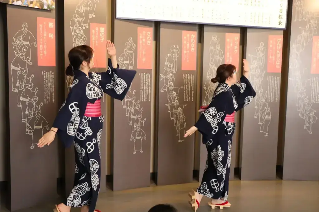 Two women in yukata dancing at the Gujo Odori.