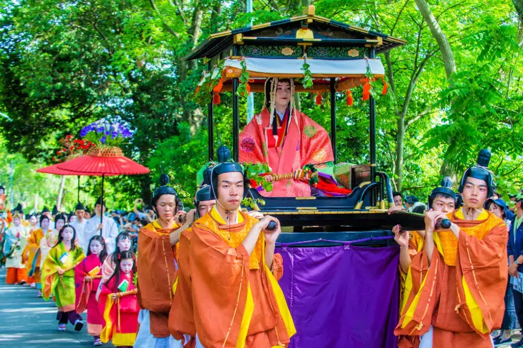 A woman dressed in a junihitoe sitting on a palanquin at the Aoi Matsuri.