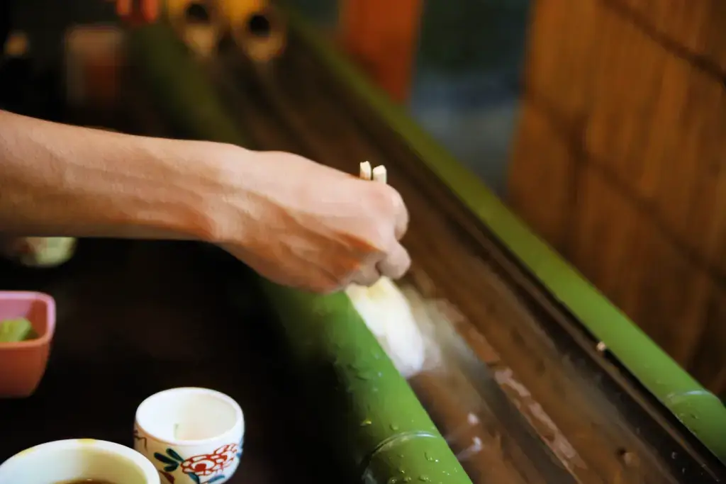 A person enjoying nagashi somen.