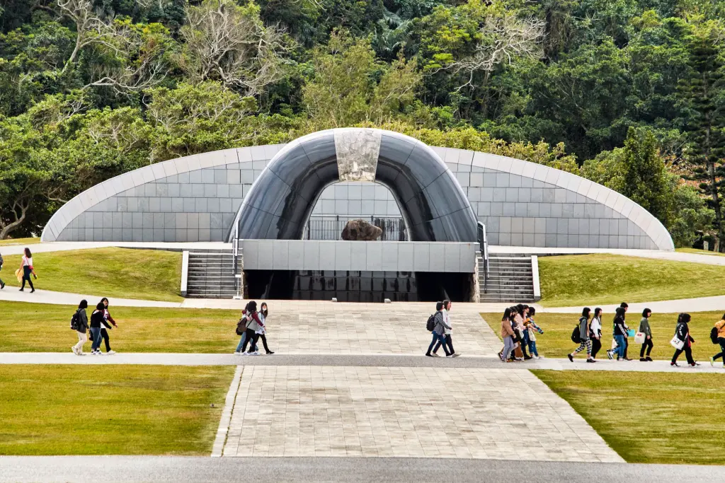 People outside of the Okinawa Peace Memorial in Itoman City .