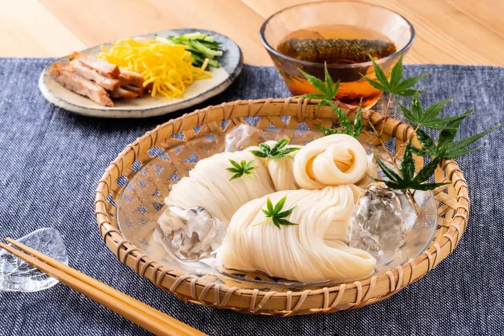 Chilled thin noodles in a woven basket of ice.