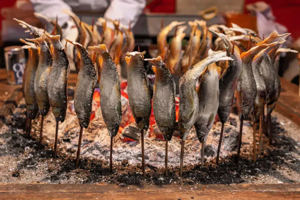 Ayu fish grilling outside.