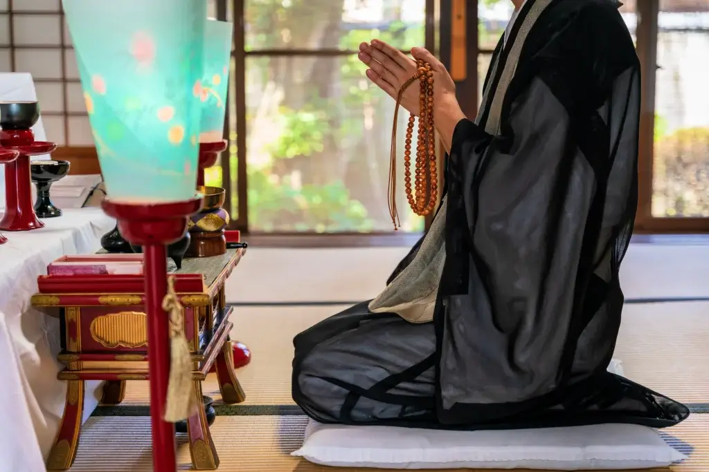 A Buddhist monk praying during higan season.