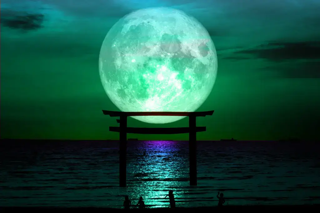 A shrine gate (torii) in Japan during a full moon.