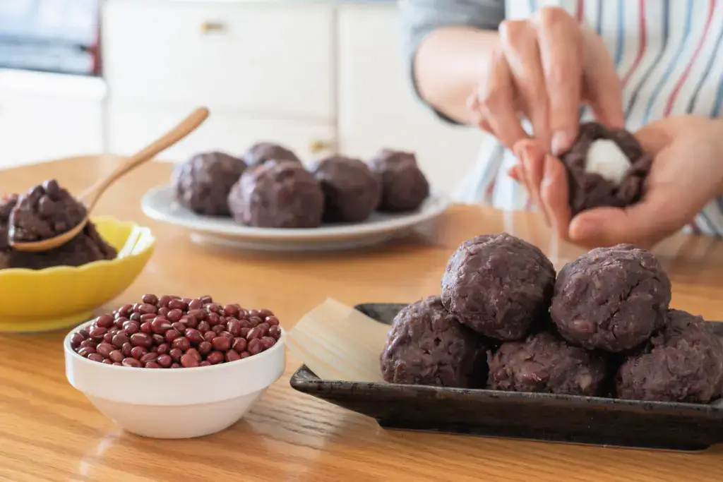 A person making ohagi in the kitchen.