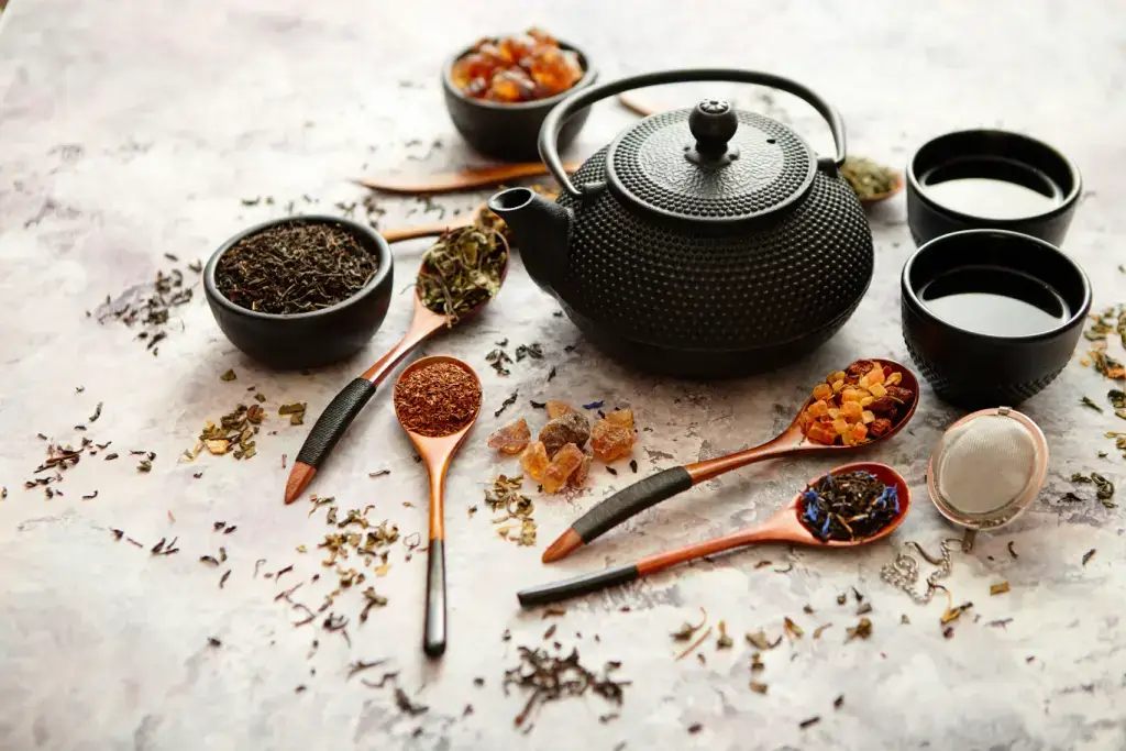 A teapot surrounded by roots and plants.