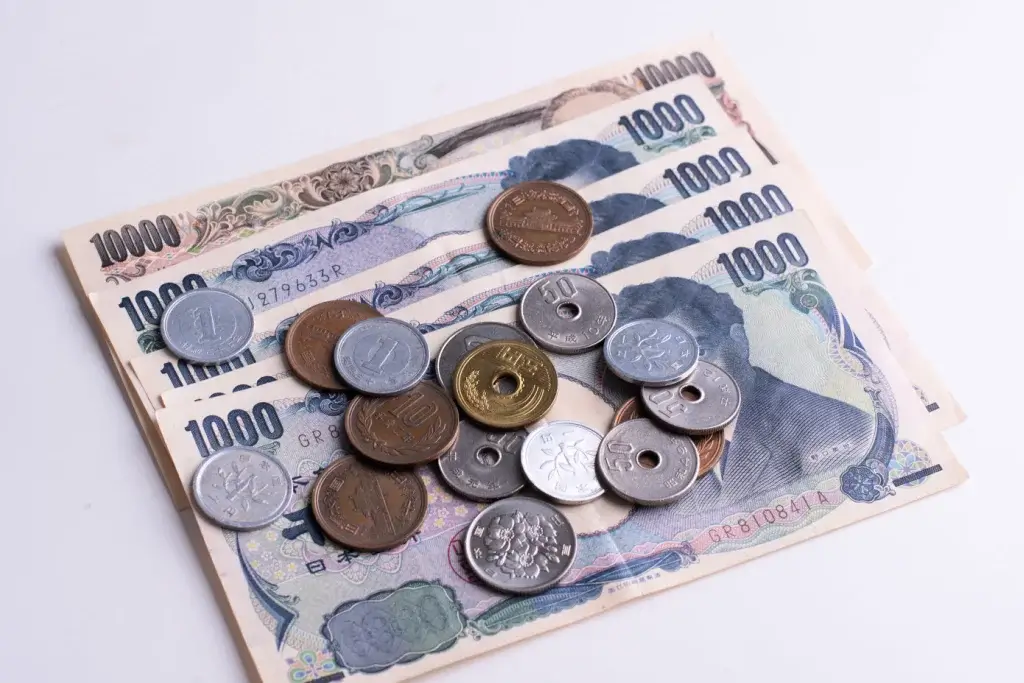 A short stack of 1,000 yen notes and coins.