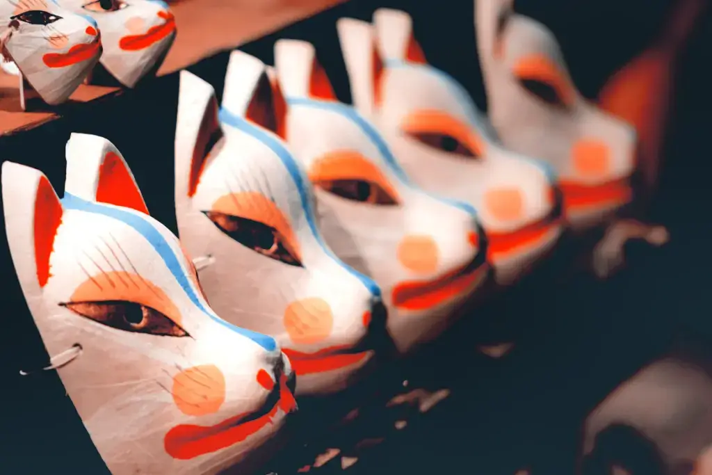 A row wof kitsune masks at a shrine.