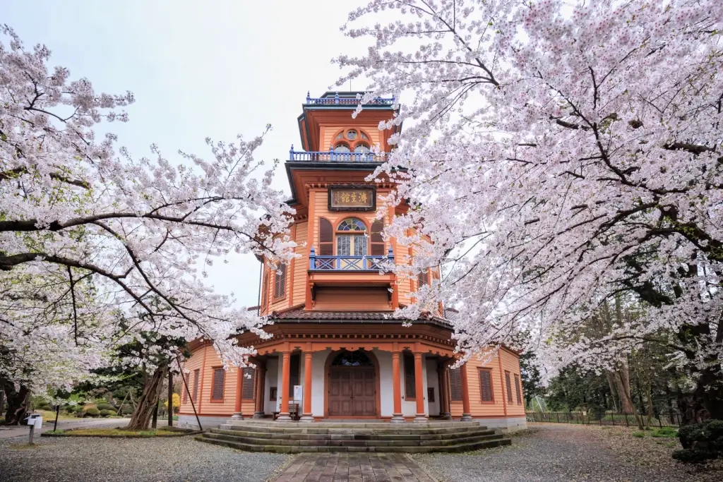 Yamagata Kyodokan in the springtime. It's surrounded by cherry blossoms.