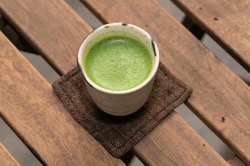 A yunomi teacup full of matcha tea.