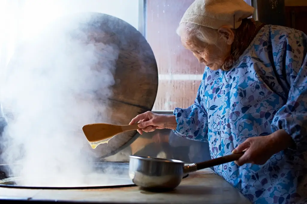 A member of the Yokoi family making rice candy.