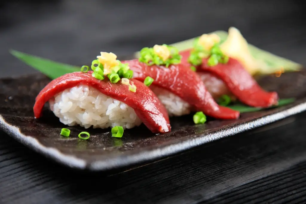 A plate of basashi sushi.