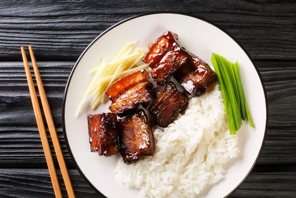 A plate of rafute with white rice.