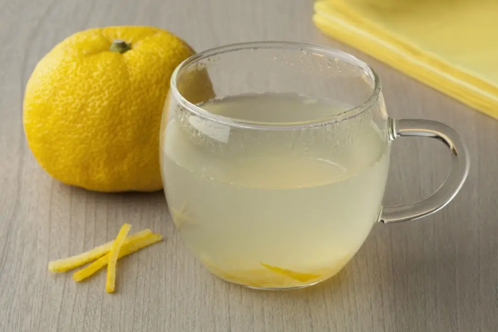 A cup of warm yuzu cha sits on a table.